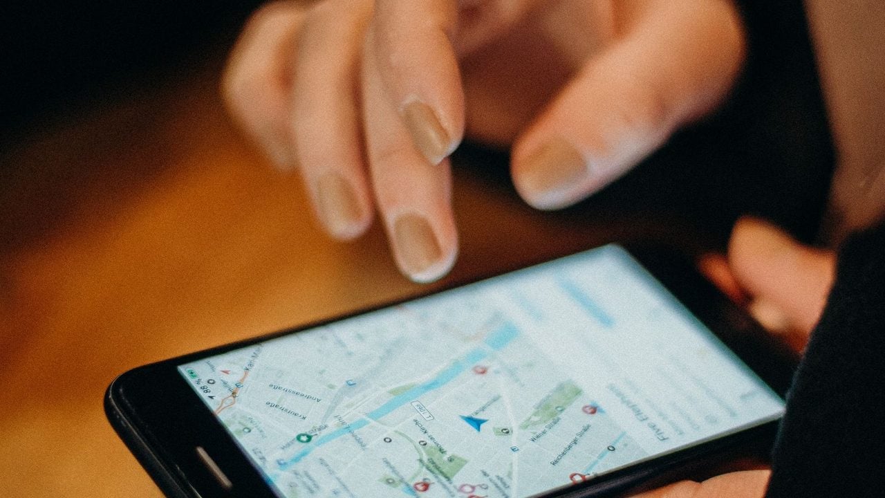 Hand tapping a local business map on a smartphone